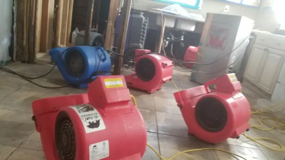 Red air movers running on a tile floor
